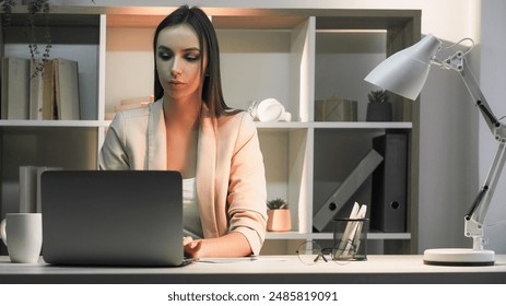 Business manager. Secretary desk. Freelance lifestyle. Concentrated woman working from home multitasking writing taking note typing mug on desk. - Powered by Shutterstock