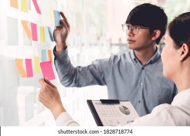 Business Manager Showing Idea For Her Team And Stick Many Memo Paper On Glass Window To Success Working In Business Meeting  Creative Office, Planning And Management Concept