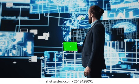 Business manager uses mockup screen next to AI neural networks, working with machine learning and cloud computing systems. Young man implementing artificial intelligence. Camera B.