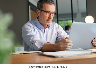 Business manager working in office on laptop