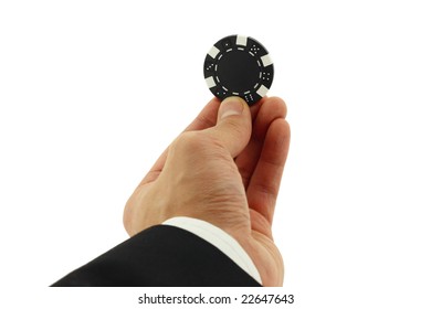 Business Man's Hand Holding A Casino Chip Isolated On White