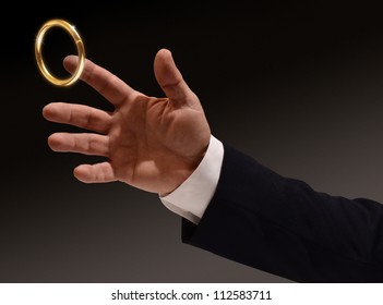 Business Man's Hand Reaching For The Brass Ring