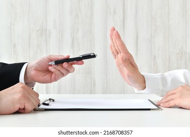 Business man's hand recommending contract and customer's hand refusing it - Shutterstock ID 2168708357
