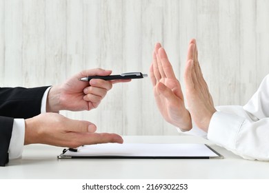 Business man's hand recommending contract and customer's hand refusing it - Shutterstock ID 2169302253