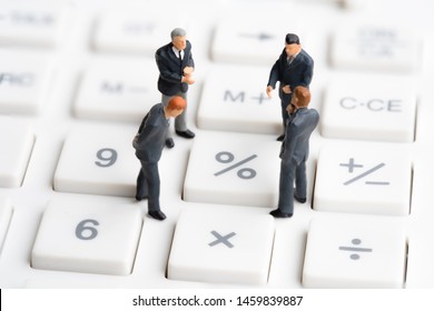 Business Mans Standing On Calculator. Interest Rate Financial And Mortgage Rates. Compound Interest Rate Calculation. Risk Management Financial And Managing Investment Percentage Interest Rates.