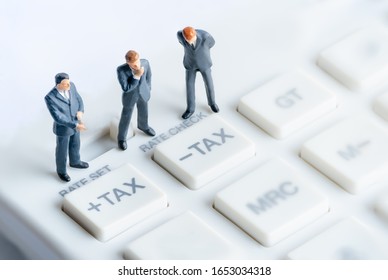Business mans standing on calculator. Calculation and tax payment. Interest rate financial and mortgage rates. Risk management financial and managing investment percentage interest rates.