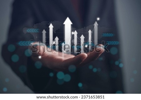 Business market growth for corporate or company. Businessman holding arrow up and analysis economic with graph data analytics. Report KPI for increase of sale success, Investment in stock market.