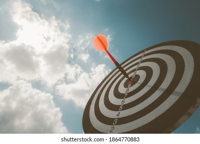 business marketing as concept. Black dart arrow hitting in the target center of dartboard Target hit in the center. - Shutterstock ID 1864770883