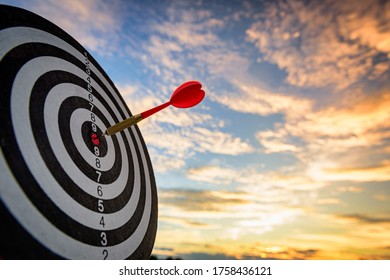business marketing as concept. Red dart arrow hitting in the target center of dartboard Target hit in the center. - Shutterstock ID 1758436121