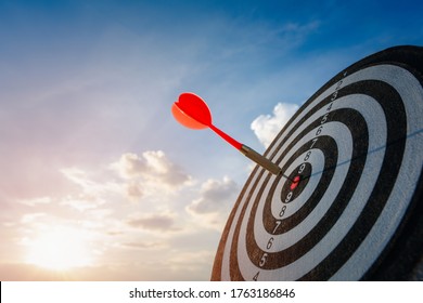 business marketing as concept. Red dart arrow hitting in the target center of dartboard Target hit in the center. - Shutterstock ID 1763186846