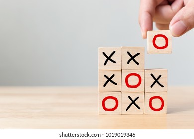Business marketing strategy planning concept. Wooden block tic tac toe board game on wood table
