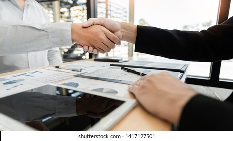 Business Meeting agreement Handshake concept, Hand holding after finishing up dealing project or bargain success at negotiation over office background.