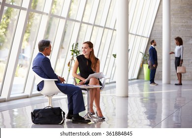 Business Meeting In Busy Office Foyer Area