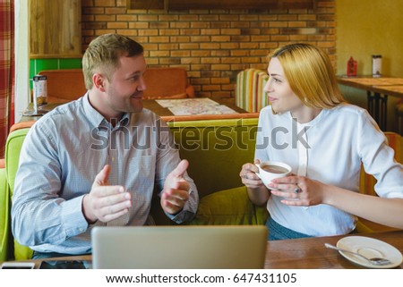 Business meeting in a cafe. happy or successful Man and woman are negotiating