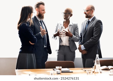 Business meeting with diverse professionals discussing business. Diverse business team in a meeting, sharing ideas and strategies. Diverse group of professional people in the meeting room - Powered by Shutterstock