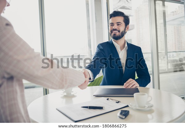 Business meeting guy welcoming new worker lady\
shaking hands big\
office