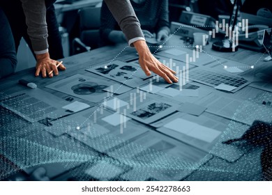 Business meeting with hands on documents, charts, and graphs. Focus on data analysis, strategy, and teamwork. Professional setting data analysis meeting with digital overlay. - Powered by Shutterstock