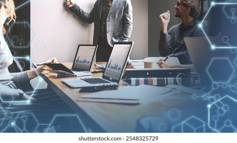 Business meeting with laptops, charts, and graphs. Diverse team discussing data and charts. Diverse business professionals in global strategic meeting. Global business connection strategy planning. - Powered by Shutterstock