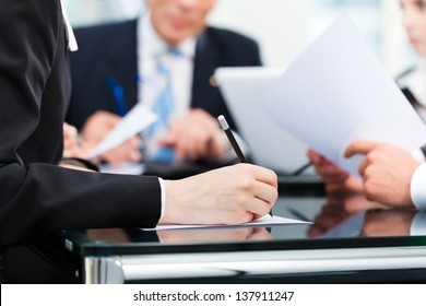 Business - Meeting In An Office, Lawyers Or Attorneys Discussing A Document Or Contract Agreement