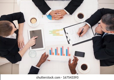 Business Meeting. Top View Of Business People In Formalwear Sitting At The Table And Discussing Something