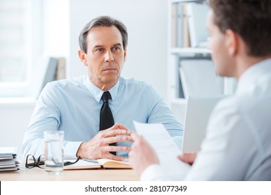 Business Meeting. Two Business People Sitting In Front Of Each Other In The Office While Discussing Something