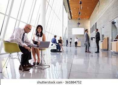 Business Meetings In Busy Office Foyer Area