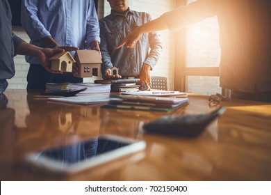 Business meetings of real estate brokers and company presidents to select a model to build a housing estate in writing and presenting to state organizations. - Shutterstock ID 702150400