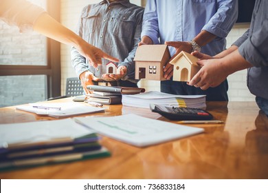 Business meetings of real estate brokers and company presidents to select a model to build a housing estate in writing and presenting to state organizations. - Shutterstock ID 736833184