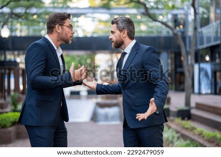 Business men aggressive fight outdoor. Conflict and fight business concept. Colleagues disputing having disagreement, diverse coworkers having conflict fight. Bad entrepreneurship.