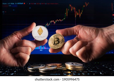 Business men holding bitcoin and ethereum coin whit computer trading chart background. Bitcoin and altcoin the most important cryptocurrency concept - Shutterstock ID 1905996475