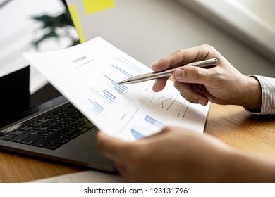 Business men are looking at the company's financial documents to analyze problems and find solutions before bringing the information to a meeting with a partner. Financial concept. - Shutterstock ID 1931317961
