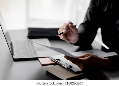 Business men are looking at the company's financial documents to analyze problems and find solutions before bringing the information to a meeting with a partner. Financial concept. - Shutterstock ID 2188260267