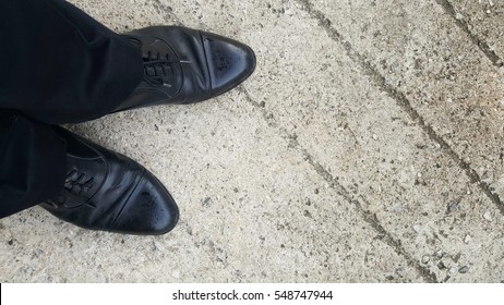 business men shoes stand on walking street
