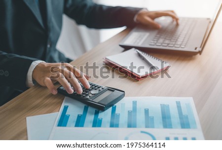 Business men use calculators to calculate business ratios. Evaluate your investment budget plan, success, cost effectiveness and profit and loss.