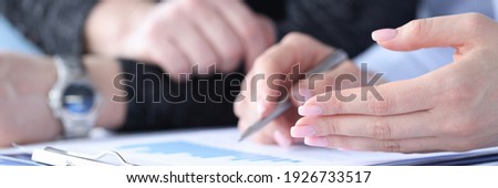 Business men and women discussing charts in documents closeup. Financial profit analysis concept