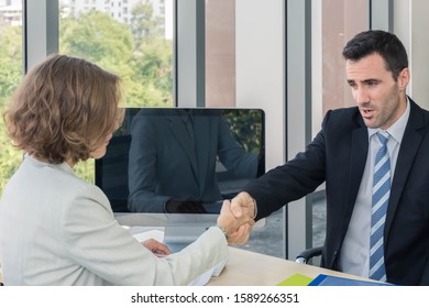 Business men and women are hand in hand to work together in the office Men and women dressed up well looking, wearing a tie suit - Shutterstock ID 1589266351