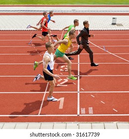 Business Metaphore Of Staying Ahead, Winning In Business,business Competition, And Continuous Improvement, Represented By A Photo Finish Of A Track Race