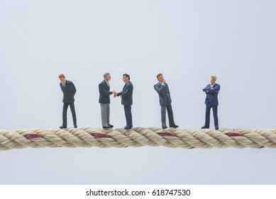 Business Miniature People Standing On A Rope