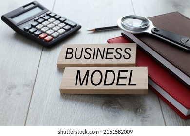 Business Model Text On Wooden Blocks On Different Notebooks