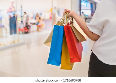 Business And Modern Lifestyle Concept.Young Woman Happy With Shopping Bags.Girl Holding Shopping Bag In Her Hand.