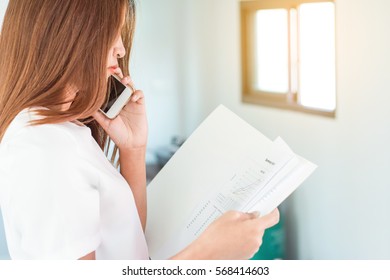Business Modern women using mobile phone with report working