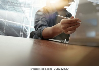 Business Moment With Laptop Computer And Graph  Diagram And Man Working In The Background                               