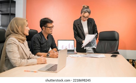 Business Muslim And Asian Woman And Man Have Meeting. Happy Fun Professional Employee Showing Team Present Company Project. Funny Beautiful Islam Person Laugh At Organization Plan In Conference Room.