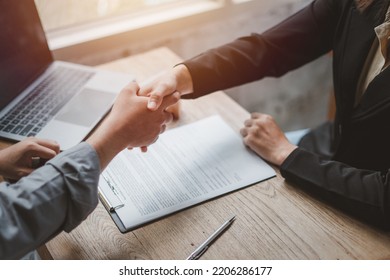 Business negotiations real estate agents women shaking hands with clients after signing property sales contracts giving advice, passing bank approvals and installments, Concept new house moving house. - Shutterstock ID 2206286177