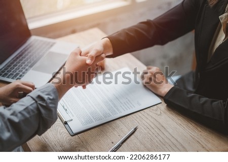 Business negotiations real estate agents women shaking hands with clients after signing property sales contracts giving advice, passing bank approvals and installments, Concept new house moving house.