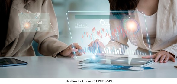Business and network connection on modern virtual interface from digital tablet, two businesswoman analyzing business growth, finance and marketing.