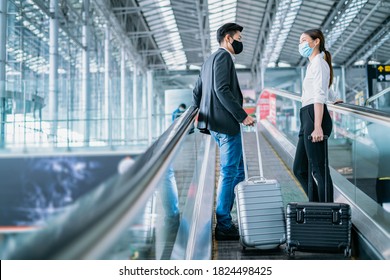 Business New normal concept.Businessman and woman wear face mask on escalator at terminal airport, New normal of people to awareness and protection for prevent coronavirus or covid-19 pandemic. - Powered by Shutterstock