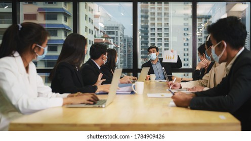 Business New Normal Practise Of Diverse Businesspeople Wearing Medical Mask To Protect Coronavirus Covid-19 Having Business Meeting In Office Meeting Room