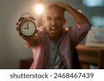 Business, office and portrait of angry man with alarm clock stress, problem or frustrated by reminder crisis. Time management, night or designer overwhelmed by pressure, anxiety or deadline mistake
