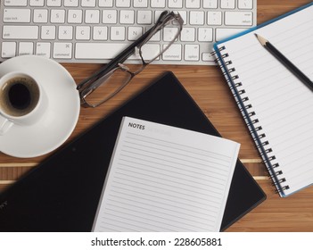 Business Office Scenario, Keyboard, Note Pad, Glasses, Tablet, Pencil And Coffee On Work Surface